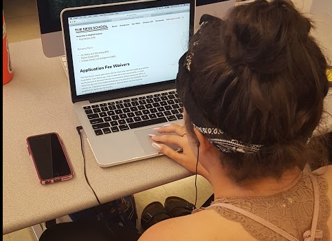 Eve Schiano ('18) checks out resources for fee waivers on her laptop.