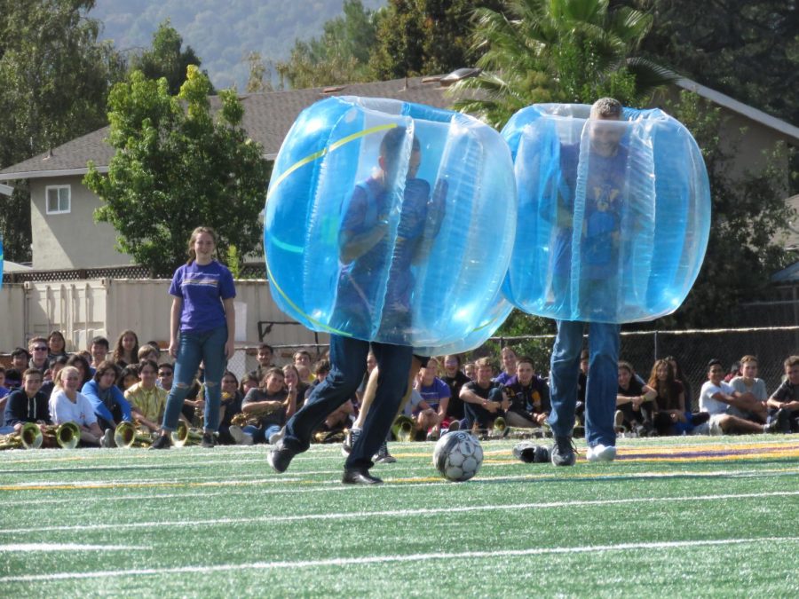 The teachers battle head-to-head in a game of bubble soccer. 