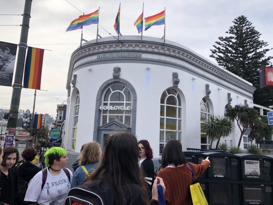 The GSA stops to admire a large rainbow flag before visiting Harvey Milk Plaza.