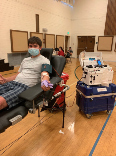Senior Horatio Wolffe gets his blood drawn while remaining safely distant from other donates. 