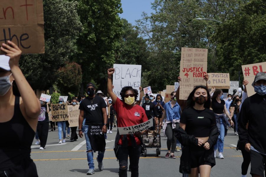 People walk the streets of Pleasanton to protest racial injustice and police brutality.