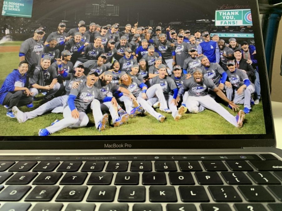 A team picture of the Dodgers after their win, including the mask-lacking Justin Turner.