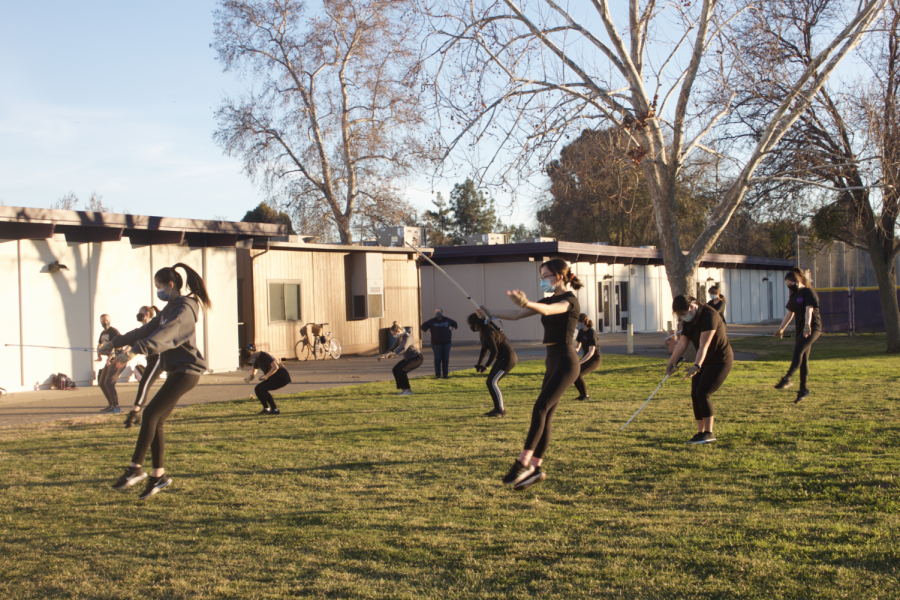 The varsity winter guard performs a routine using sabres as equipment.