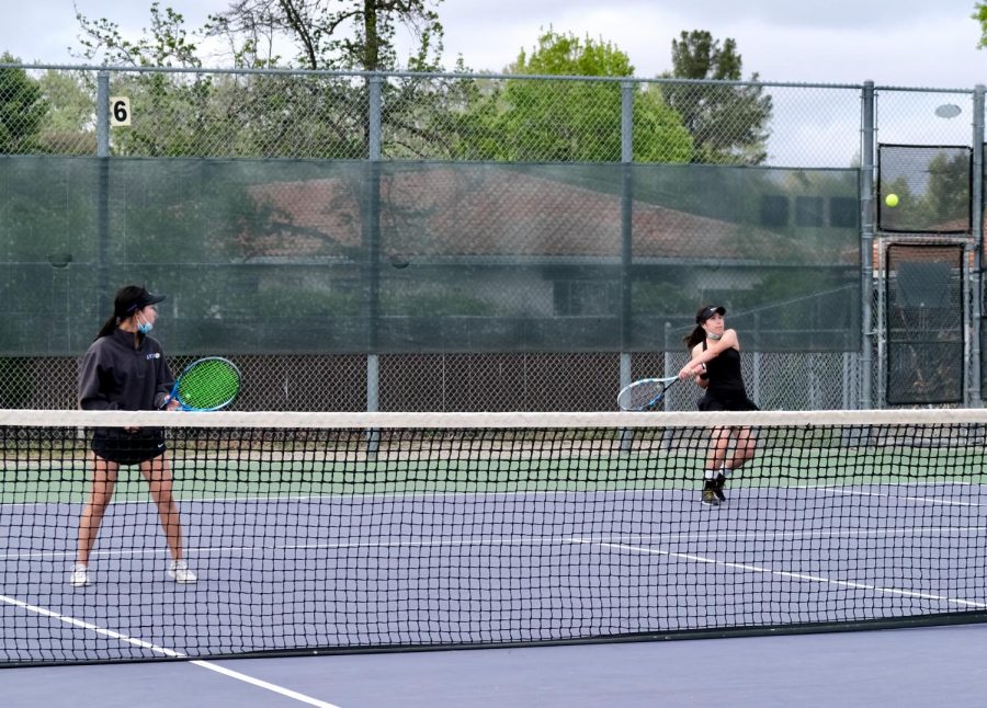 During their doubles game, Y-Duyen Nguyen (23)gets ready for the next round while her partner, Emma Wen (22), hits hard to get the point.
