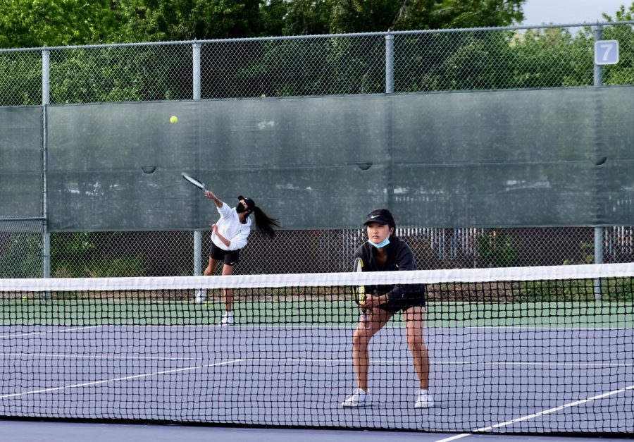 While Parna Praveen ('21) serves, her partner Hanna Min ('22) stays ready for the opponents' receive.
