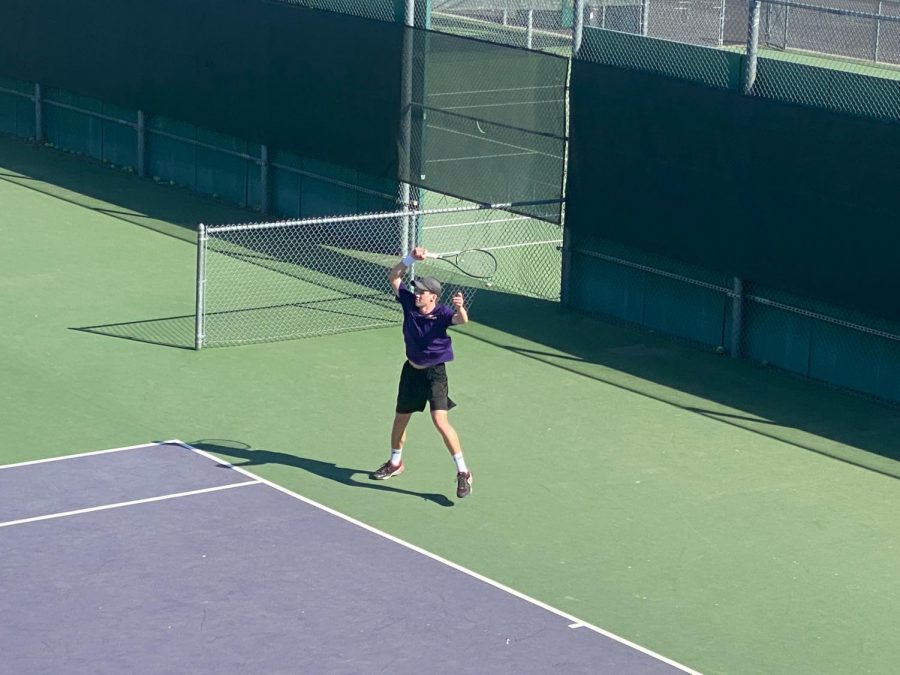 Brett Miller ('21) jumps in happiness as he wins his point in his singles match. 