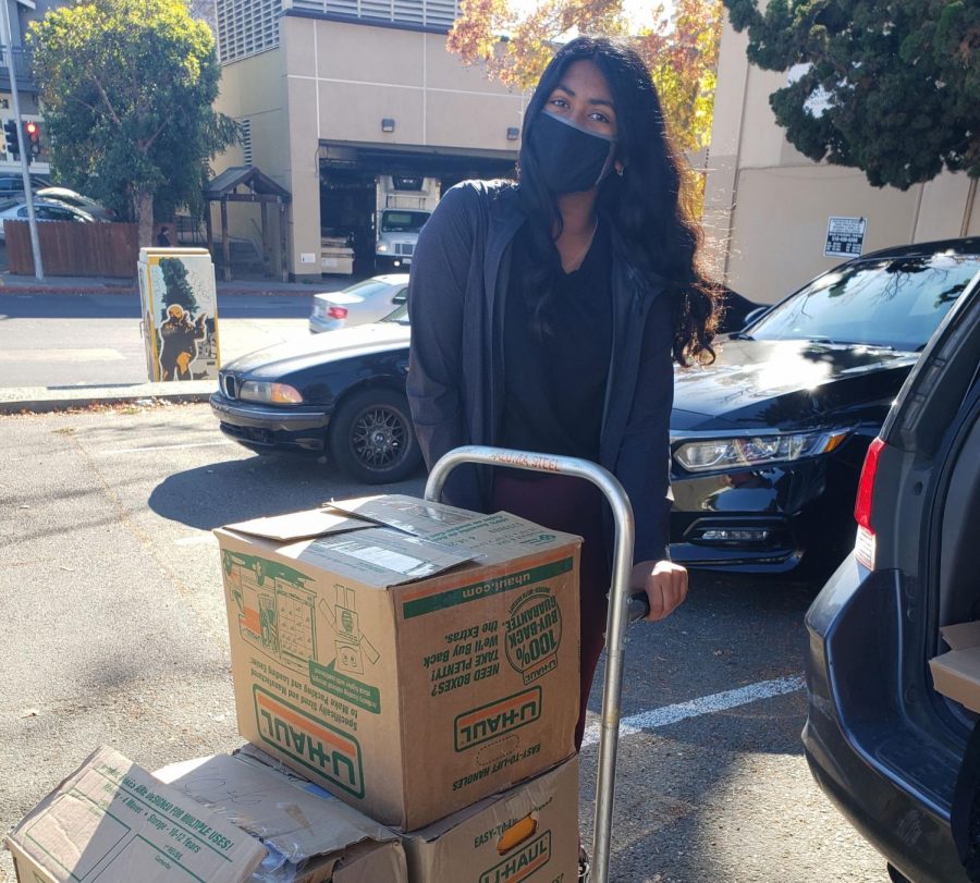 Anika Aeka (24) smiles as she drops off books.