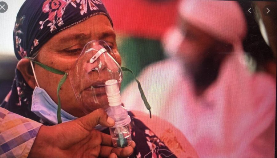 A woman is given oxygen, as she struggles to breathe due to the effects of Covid. Originally posted: BBC News. 