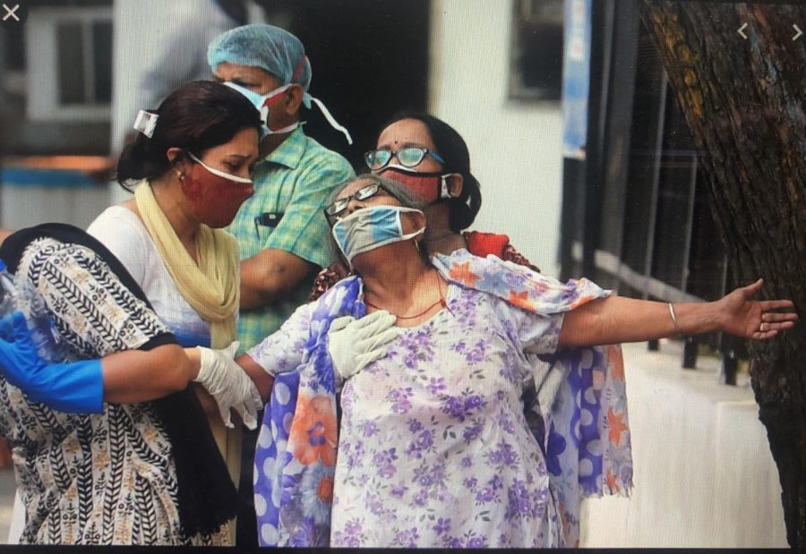 A woman is helped to walk, as she struggles with the fight against the Covid virus. Originally posted: AlJazeera.