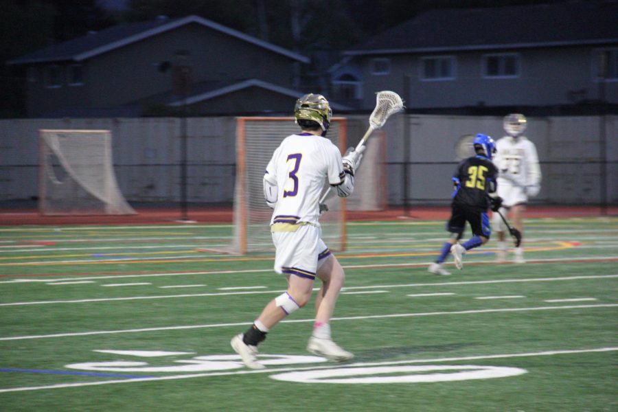 #3 Ryan Brace ('22) runs downfield with the ball.
