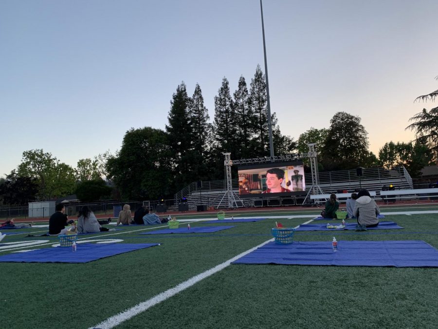 The movie begins and groups of up to four students sit on socially distanced picnic blankets with a basket of snacks provided by the event organizers.