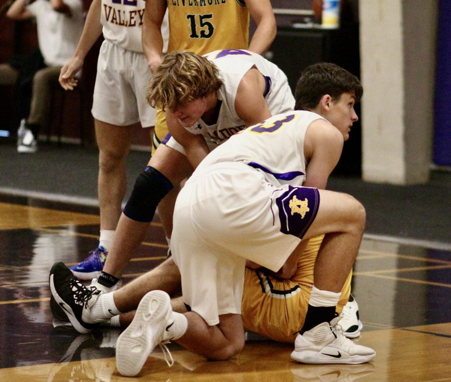 Javier Gros-Suarez ('23) and Jackson Morgenstern ('23) wrestle to take the ball from the opponent.