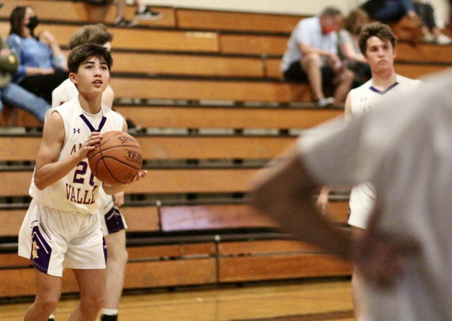 Tyler Cheng (23) looks up to the hoop, judging the perfect time to shoot to get a point.