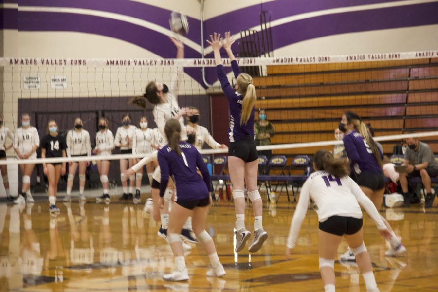 #7 Jaiden Reilly (21) jumps to block a spike.
