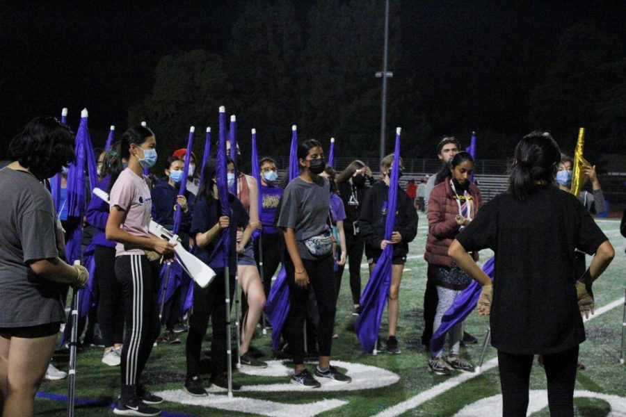 The colorguard meet with the captains to reflect on show performance and listen to announcments.