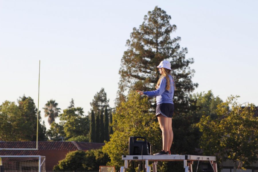 Solo shot of senior drum major, Julia Szambelan (22), conducting the band to success.