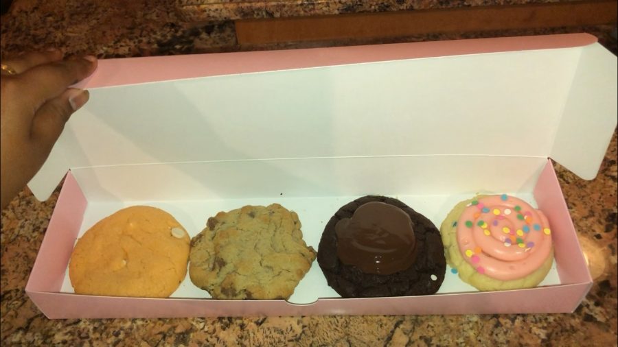 Crumbl Cookies are easily transportable in their pink box.