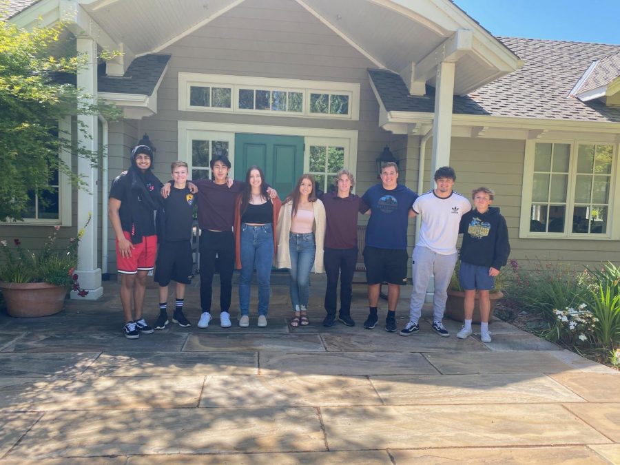 A few students from the Mr. Amador team stand in front of a home after a day of planning.