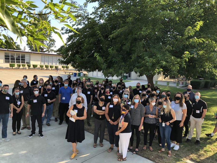 Teachers, wearing black and stickers, greeted and showed their support for Amador Valley students as they show up for the first day of school. 