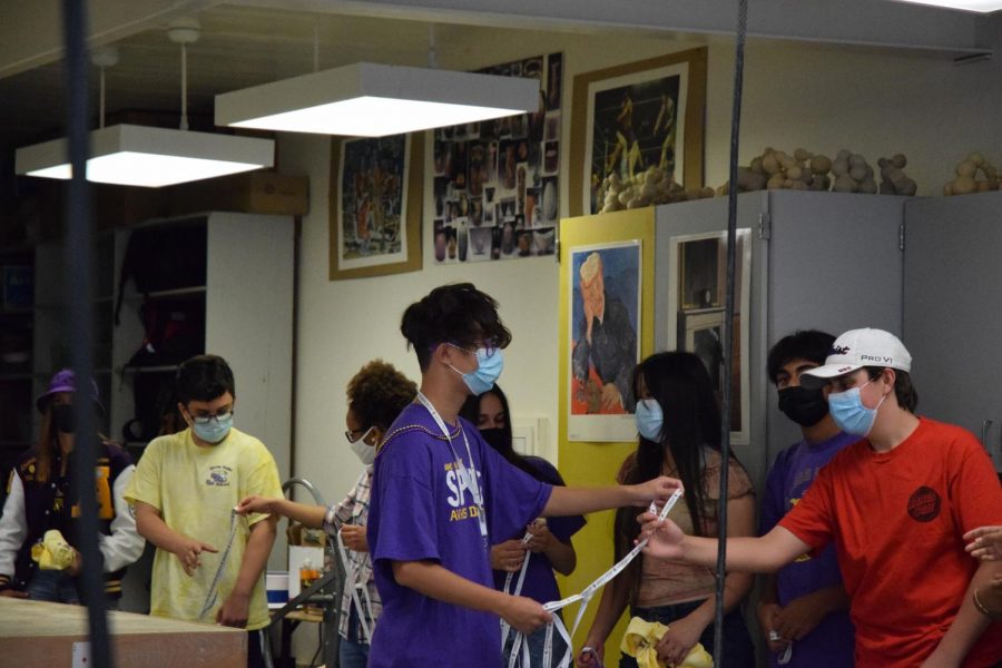 As the leadership kids happily go into the rooms they hand the students Amador Lanyards in preparation for the home game.