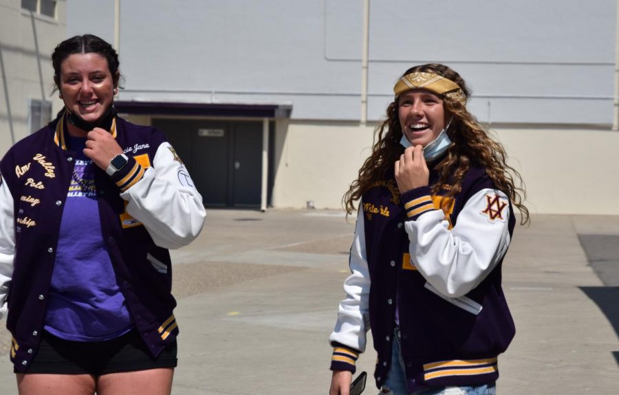 Hannah Walder (‘22) and Gracie Quinn (‘22) take a quick break and deep breath before they head into the next room to hype up the students for the big game.