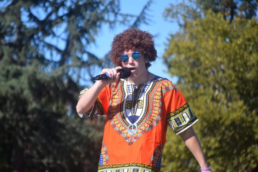 Connor Dantzig (22) hosts the homecoming rally dressed in 70s gear, the theme for seniors.