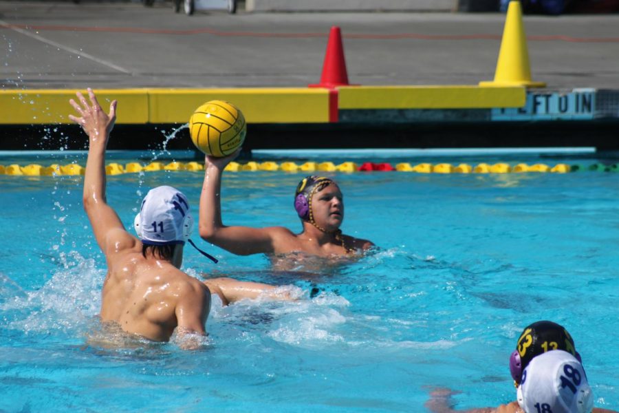 Irvington defenders approach Kenney ('25) as he looks to score.
