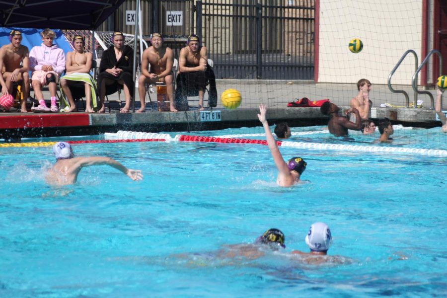 Amador defends their goal as players look on from the sidelines.