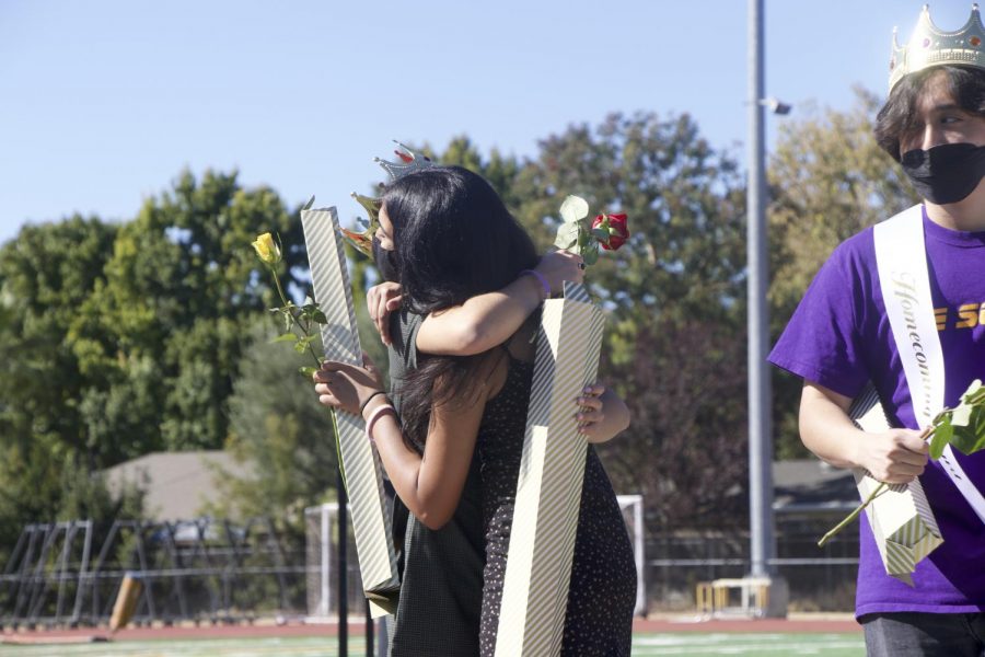 Homecoming court contestants hug each other after receiving their results.