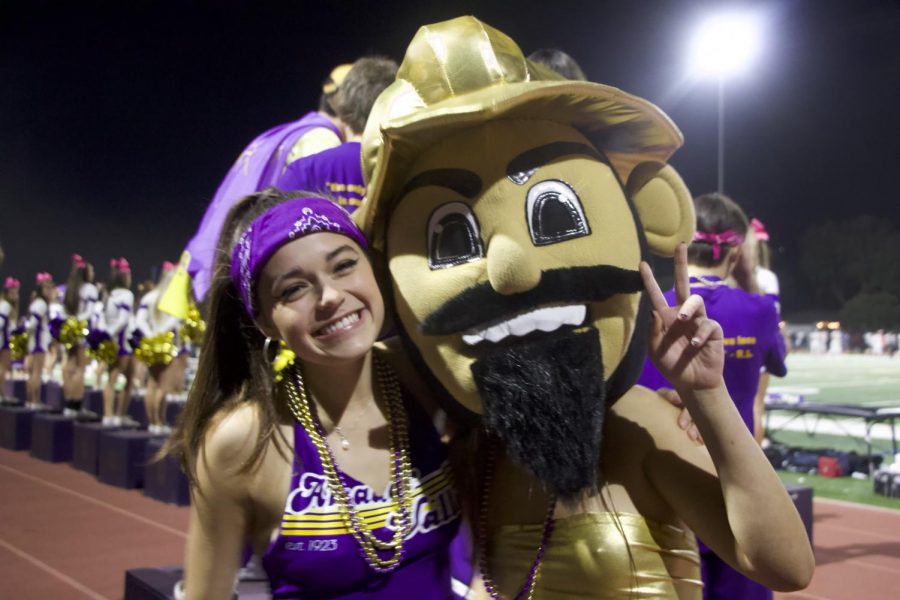 Ashley Torres (22) smiles with Sydney Seltzer (22) who is wearing the don mascot costume.