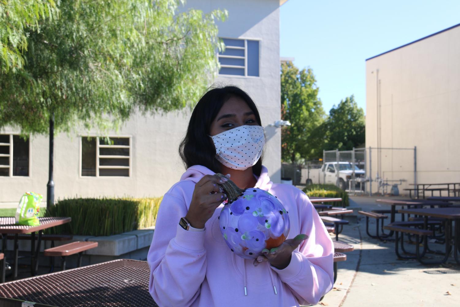English second language students participate in a pumpkin painting social