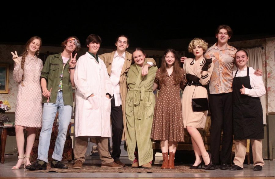 The actors crowd to take a group picture after their successful first performance.