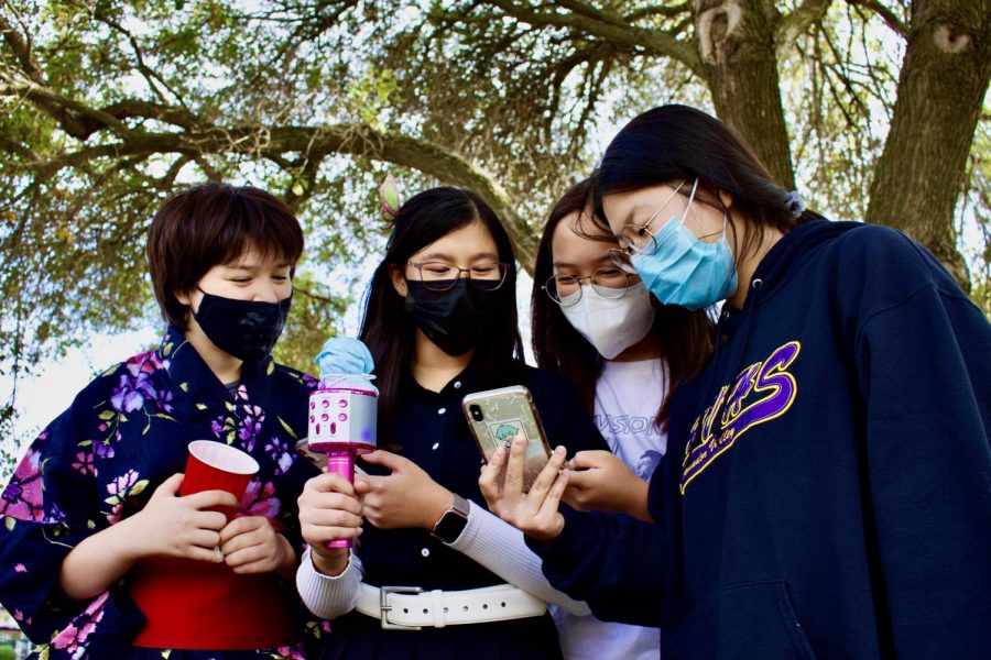 Keira Lai (24), Suah Oh,(24), Joyce Kuang (24), and Emi Ray (25), huddle together while singing Japanese karaoke.