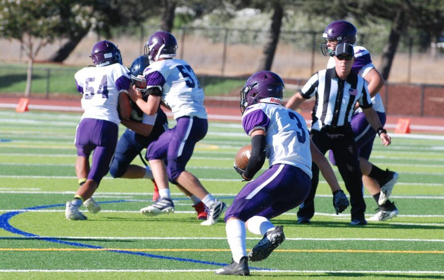 The Amador team unites to clear the path as a runner dashes with the ball.