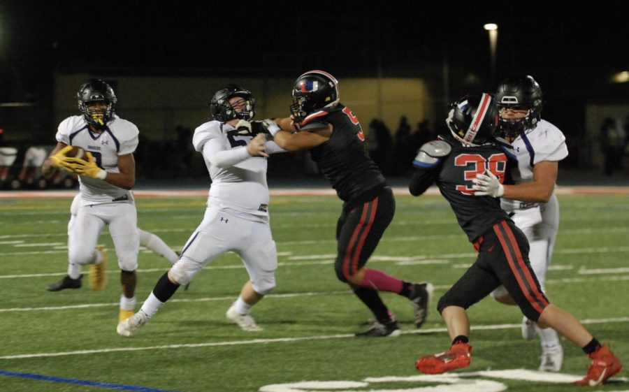 Players attempt to hold each other back as Amador runs with the ball.