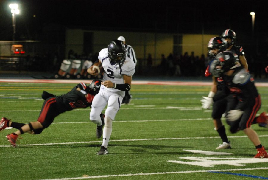 Rival players dive in an attempt to capture the ball currently in possession of Amador.