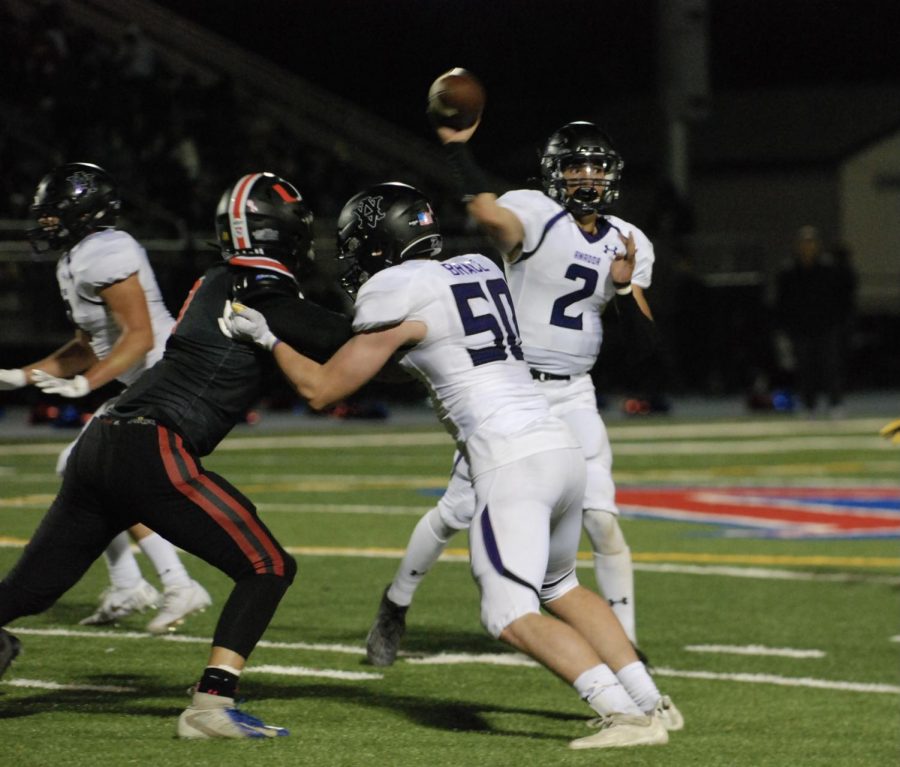 Two football players tussle fiercely.