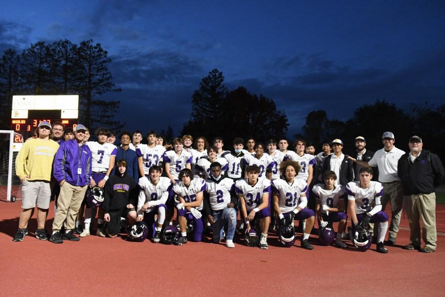 The football team looks at the camera for a team photo.