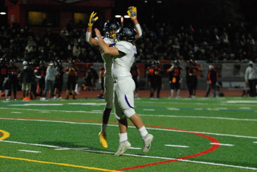 Two players high-five in a show of team spirit.