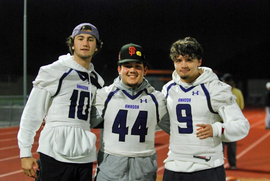 Football players smile for the camera after a good match.