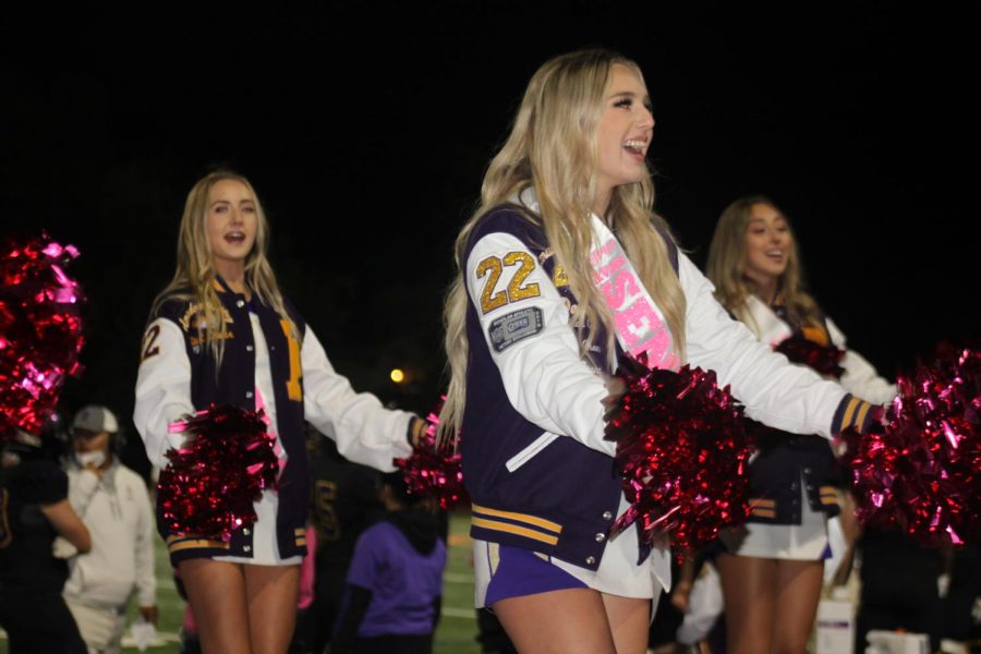 Cheerleaders love to hype up the crowd with their special pink-out pom poms.