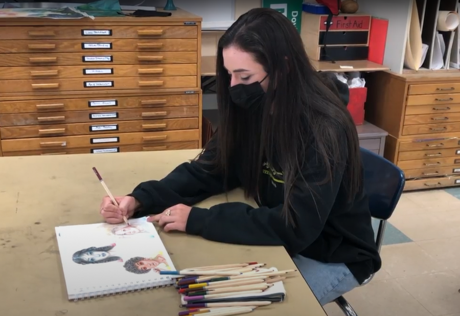 Morgan Notari ('22) uses color pencils to finish a drawing in the Studio Art classroom.