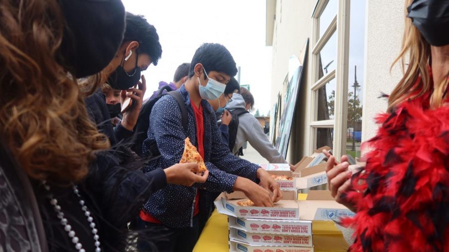 Juniors dig into the boxes of Dominos pizza, eager to be a part of the celebrations.