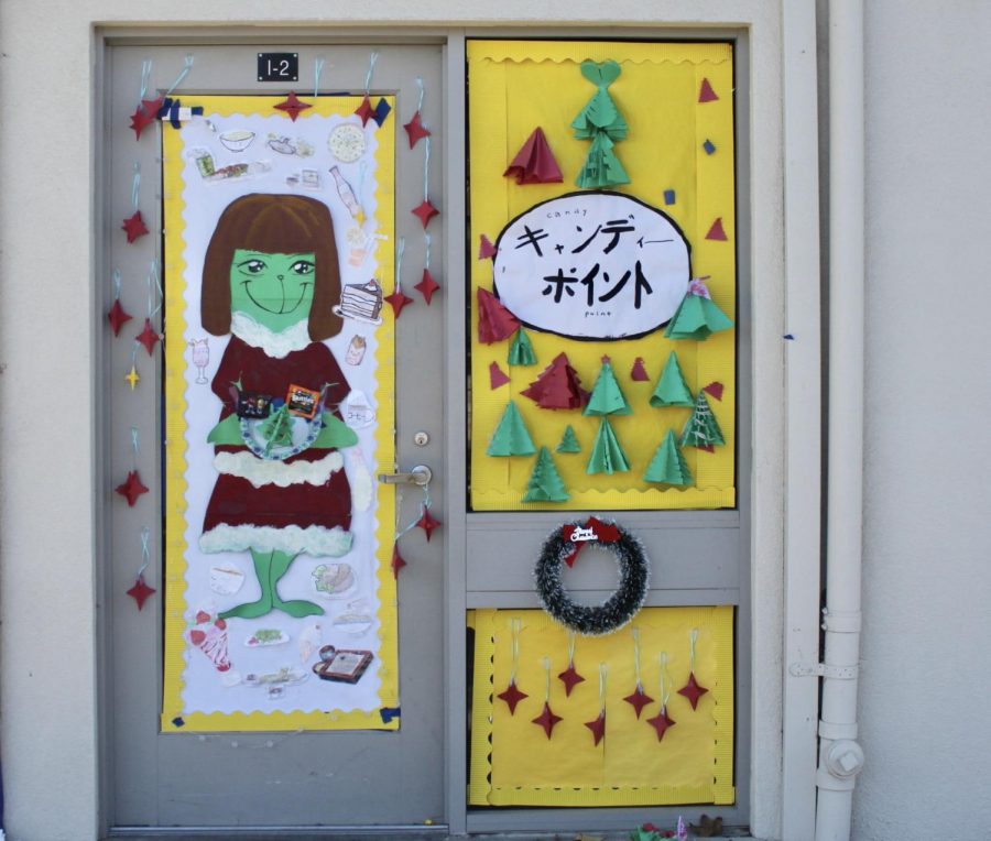 At I-2, the classroom of Japanese, students work together designing their door with an idea based on the Christmas cartoon combed with the hairstyle of the teacher to create uniqueness.