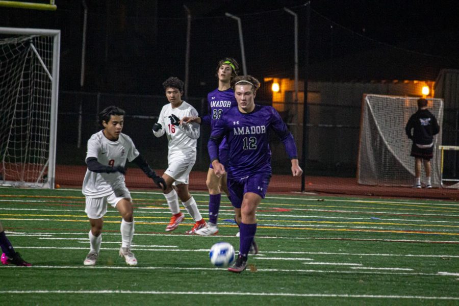 Andrew McMasters (22) prepares to pass the ball to a teammate down the field.
