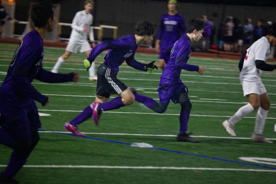 [From left to right] Fionn Conway (22) and Kyle Larsen (22) sprint to take control of the ball.