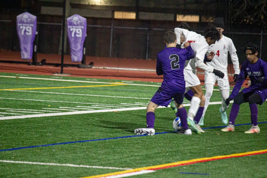 Jan Schullerus ('24) holds back Livermore to prevent them from stealing the ball.
