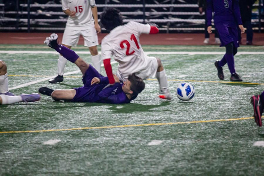 Jan Schullerus ('24) crashes to the ground after sliding to protect the ball.
