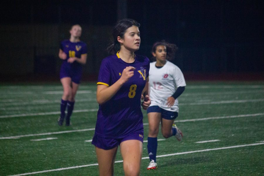 Lorraine Miller ('25) runs to steal the ball.
