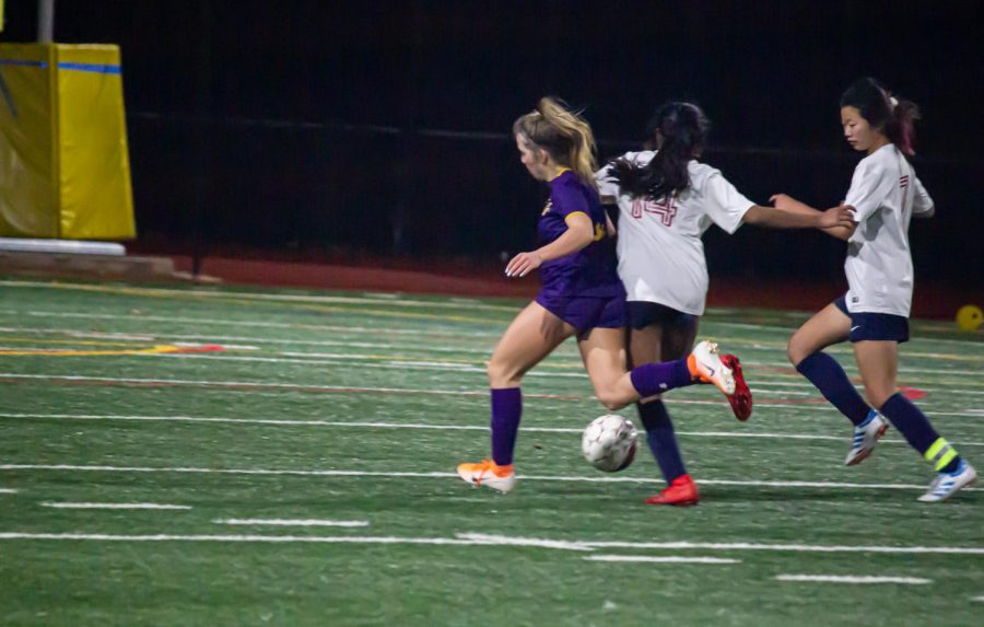 Presley Cash (25) collides with a rival player as they race to get control of the ball.